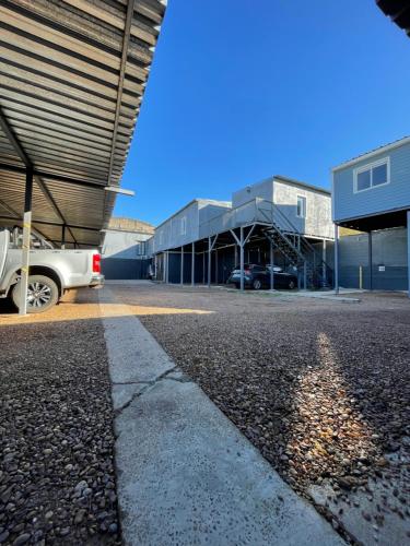 a parking lot with a car parked in front of a building at Loft & Suites Centro in Salto