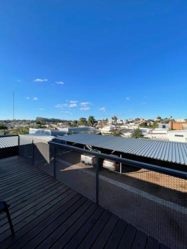 a balcony with a view of a roof at Loft & Suites Centro in Salto