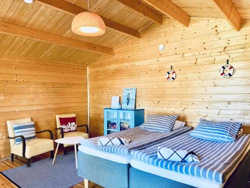 a bedroom with a large bed in a wooden room at Wästinn in Vöyri
