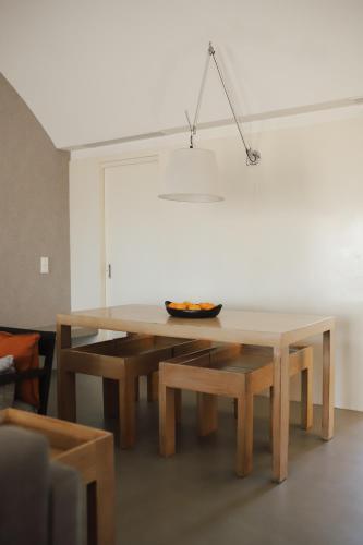 a table and benches in a living room at Herdade Do Touril in Zambujeira do Mar