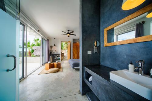 a bathroom with a sink and a mirror at Villas La Mar - Adults 15 plus in Todos Santos