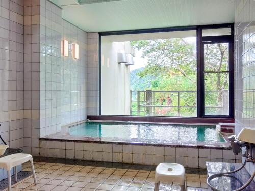 a bathroom with a swimming pool with a window at Kami - Hotel / Vacation STAY 15957 in Kami