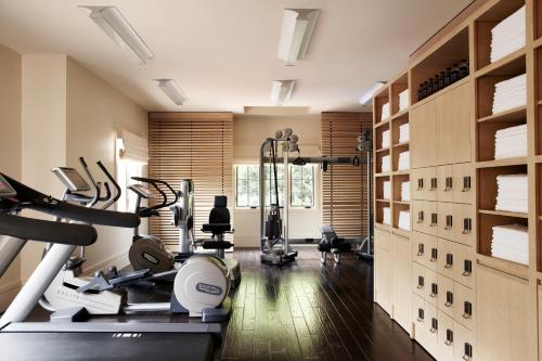 a gym with treadmills and ellipticals in a room at Hotel Bel-Air - Dorchester Collection in Los Angeles