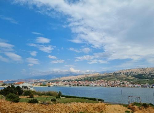 a view of a large body of water with houses at Apartments Šešo in Pag
