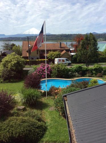 a flag in the yard of a house with a pool at Hotel El Ciervo in Villarrica