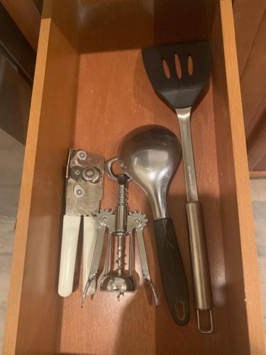 a wooden box with some utensils in it at LuxHome Suites in Mansion in Riverside