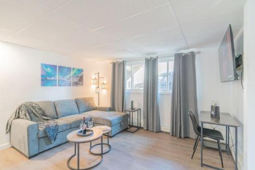 a living room with a couch and a table at Executive Work Space With Modern Charm in Fairbanks