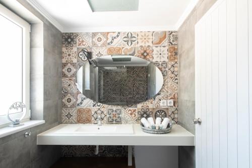 a bathroom with a sink and a mirror at ALMA HILLS Gialova in Gialova