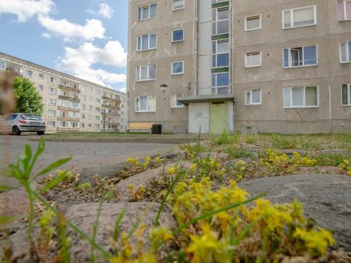 an empty parking lot in front of a building at Jūras 4 Apartament in Ventspils