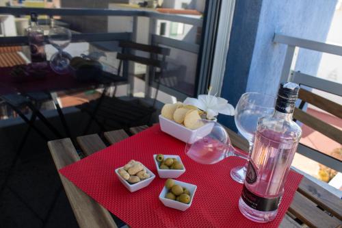 stół z butelką wina i talerzami żywności w obiekcie PUESTA DE SOL RENTALS 2AJ w mieście Playa de San Juan