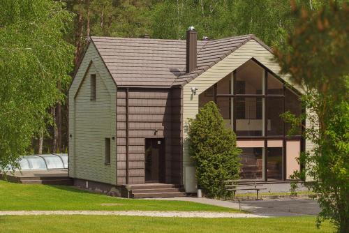 a small house with a green and brown at Vezezeris in Gaugariai