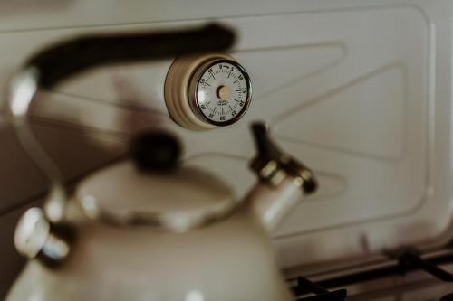a clock sitting on top of a tea kettle at Marko's eco cabin in Bled