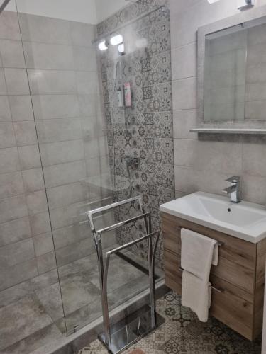 a bathroom with a sink and a shower at Eden City Home in Győr