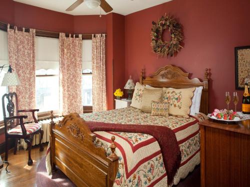 a bedroom with a large bed with red walls at Brickhouse Inn B&B in Gettysburg