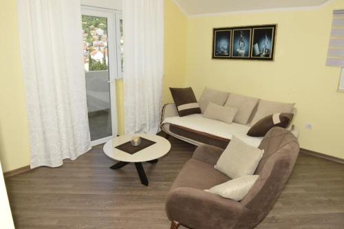 a living room with a couch and a table at Dreams tivat in Tivat