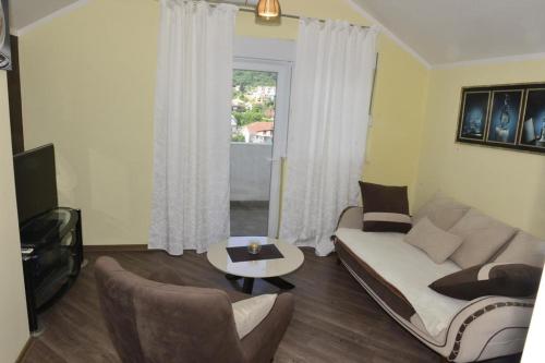 a living room with a couch and a table at Dreams tivat in Tivat