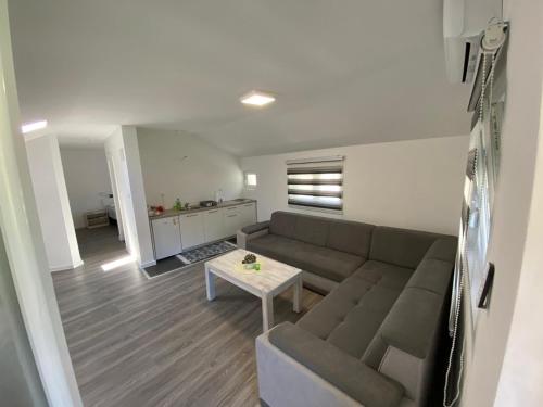 een woonkamer met een bank en een tafel bij TIRYAKI in Mostar