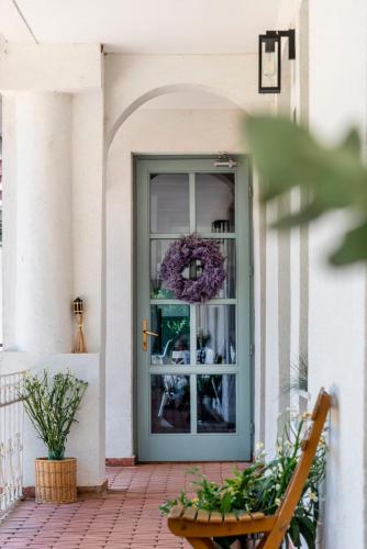 a door to a house with a wreath on it at Berky Kúria - Stylish cottage in the Hills of Tolna for 16people in Nagykónyi