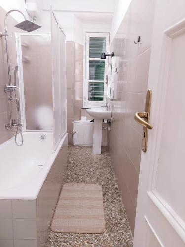 a white bathroom with a sink and a mirror at Genova Rooms Brignole B in Genoa