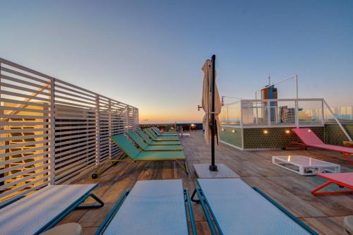 a balcony with chairs and a pool on a ship at IKYK Hotel- IK Collection in St Julian's