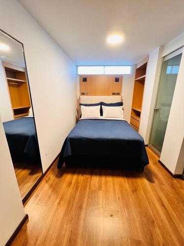 a bedroom with a bed and a mirror at OQ STANDARD HOTEL - Airport in Arequipa