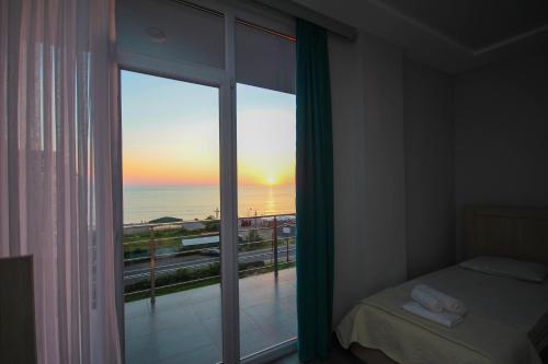 a bedroom with a window with a view of the ocean at Guest House 99 in Batumi