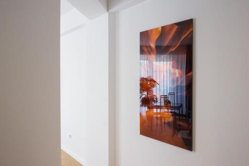 a picture hanging on a wall in a room at Pink Sahara near City Center in Oradea