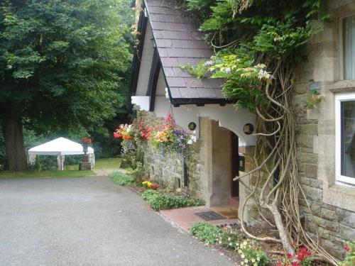 a house with flowers on the side of it at St David's Guesthouse in Haverfordwest