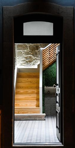 a door to a house with a wooden entrance at 6/4 de Lamego in Lamego