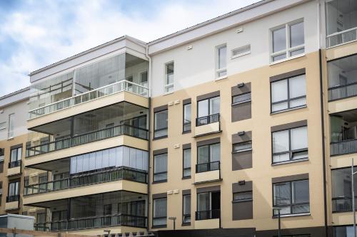 an image of an apartment building with glass balconies at Rauma City Center Studios in Rauma