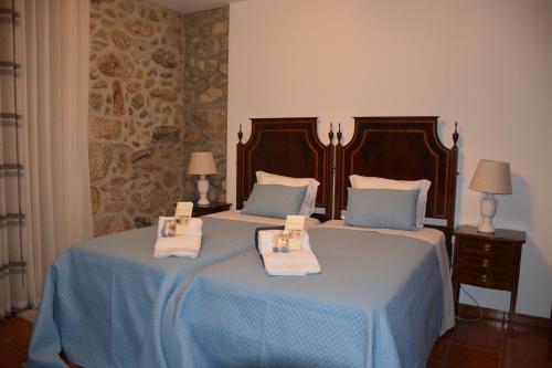 a bedroom with two beds with towels on them at Quinta da Cachada in Moure