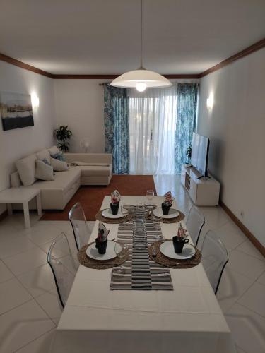 a living room with a white table and chairs at Vilamoura Marina, Av Tivoli in Vilamoura