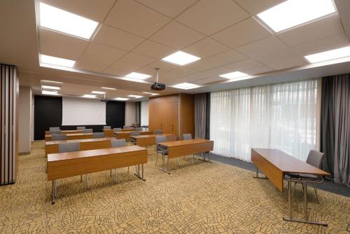 a conference room with tables and chairs and a podium at Park Inn by Radisson Istanbul Atasehir in Istanbul