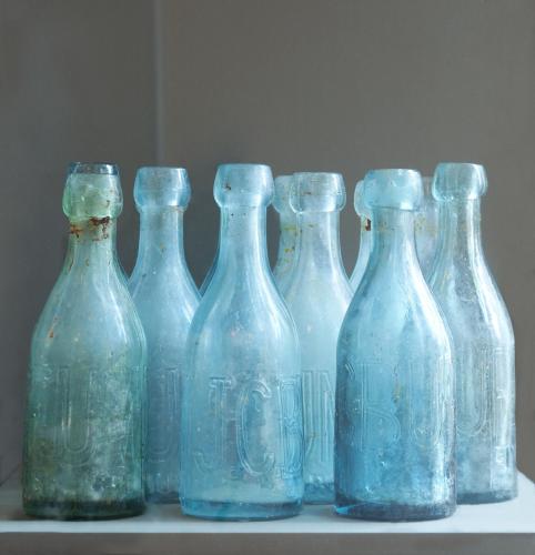 a group of blue glass bottles sitting on a table at Fairmont Pittsburgh in Pittsburgh