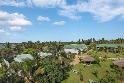an aerial view of a resort with palm trees at Radisson Resort Pondicherry Bay in Pondicherry