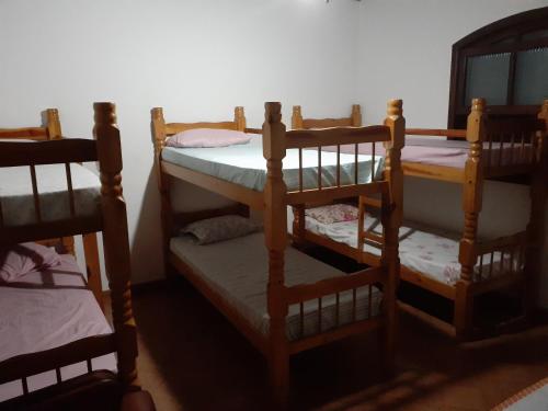a group of four bunk beds in a room at Sítio Pandoro in Atibaia