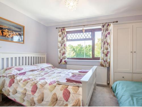 a bedroom with a bed and a window at 40 New Row in Pwllheli