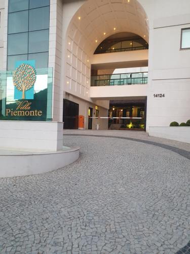 a building with a tree sign on the side of it at Casa Villa Constanza in Itaipava