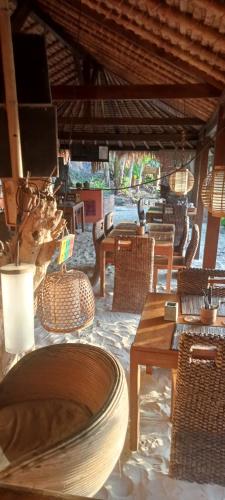 a restaurant with tables and chairs and tables and chairs at Tanjungan in Gili Gede
