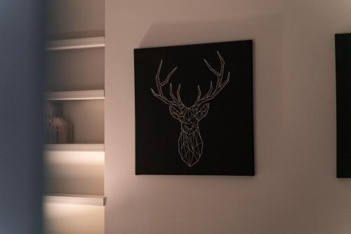 a picture of a deer with antlers on a wall at Stunning 1Bd with Castle View in Windsor