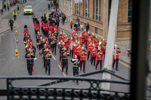 a marching band in a parade down a street at Stunning 1Bd with Castle View in Windsor