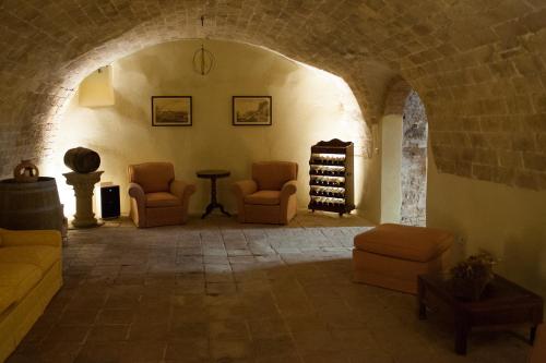 a room with couches and chairs in a building at Tenuta Mocajo in Guardistallo