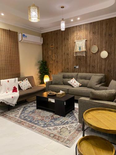 a living room with a couch and a table at Bohemian style in Abha