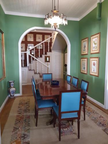 a dining room with a wooden table and chairs at Casa Villa Constanza in Itaipava