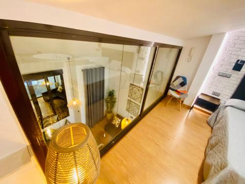 a view of a living room with a glass wall at SUITE SORPRESA VuT LA TABERNA in Arenas de San Pedro