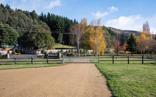 a dirt road in a field with a fence at Guest Suite in Peaceful Location Roxburgh in Dumbarton