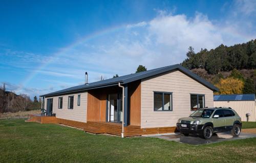 a small house with a car parked in front of it at Guest Suite in Peaceful Location Roxburgh in Dumbarton