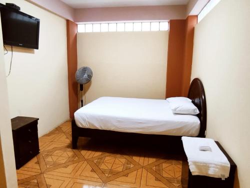Ένα ή περισσότερα κρεβάτια σε δωμάτιο στο Hostal Muchik