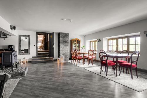 a dining room with a table and chairs at Lielkalnu Muiža in Blome