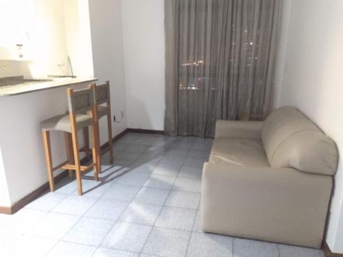 a living room with a couch and a table at Jardim de Allah in Campos dos Goytacazes